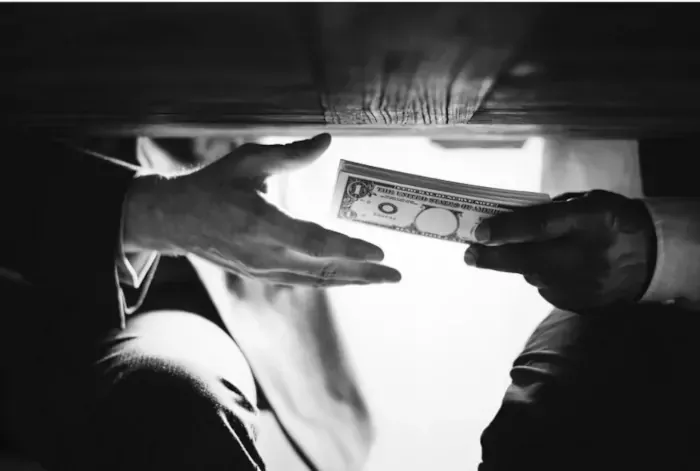 Best Fed Cats - image of money changing hands under a table  